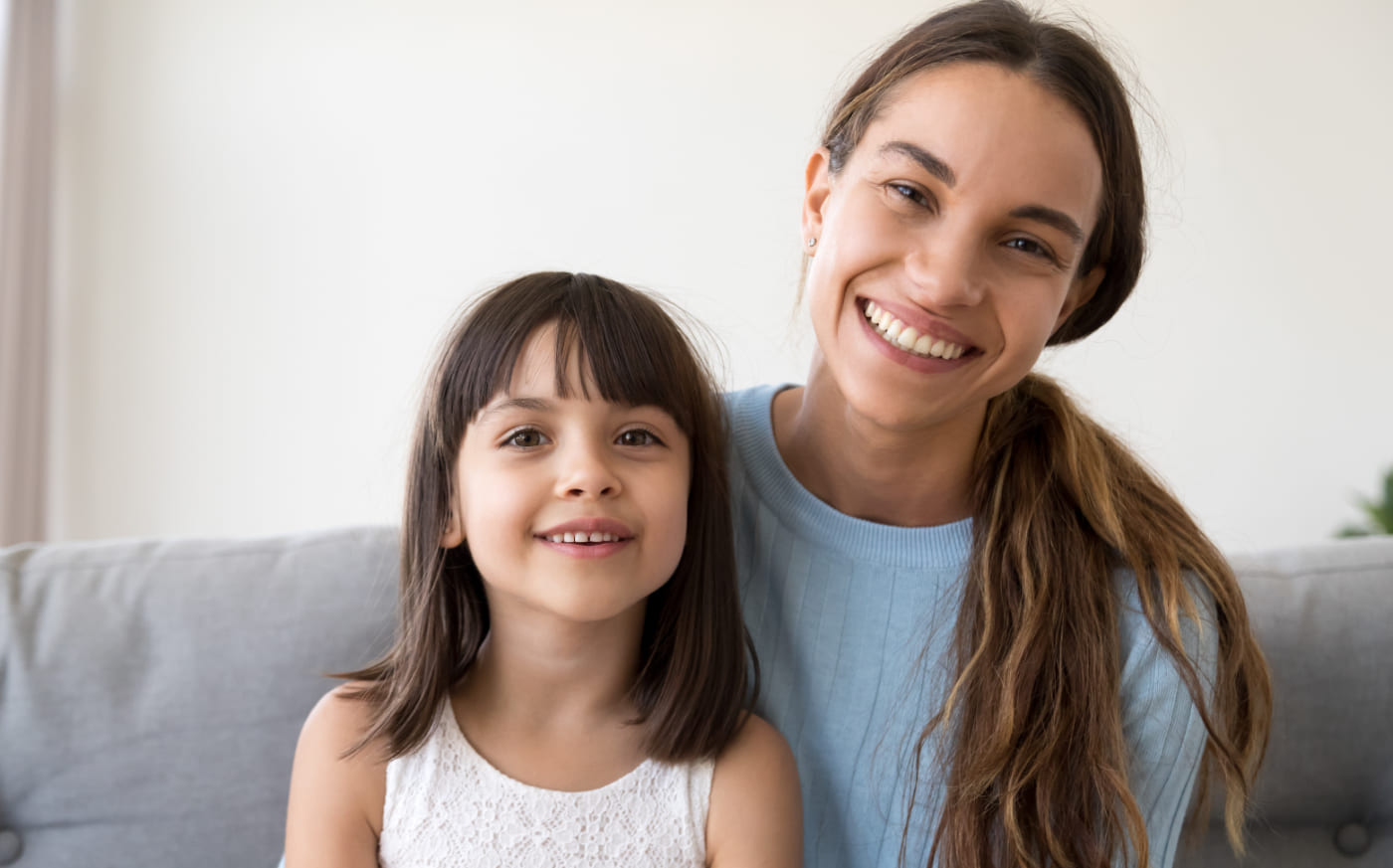 Family of four and two with braces smiling