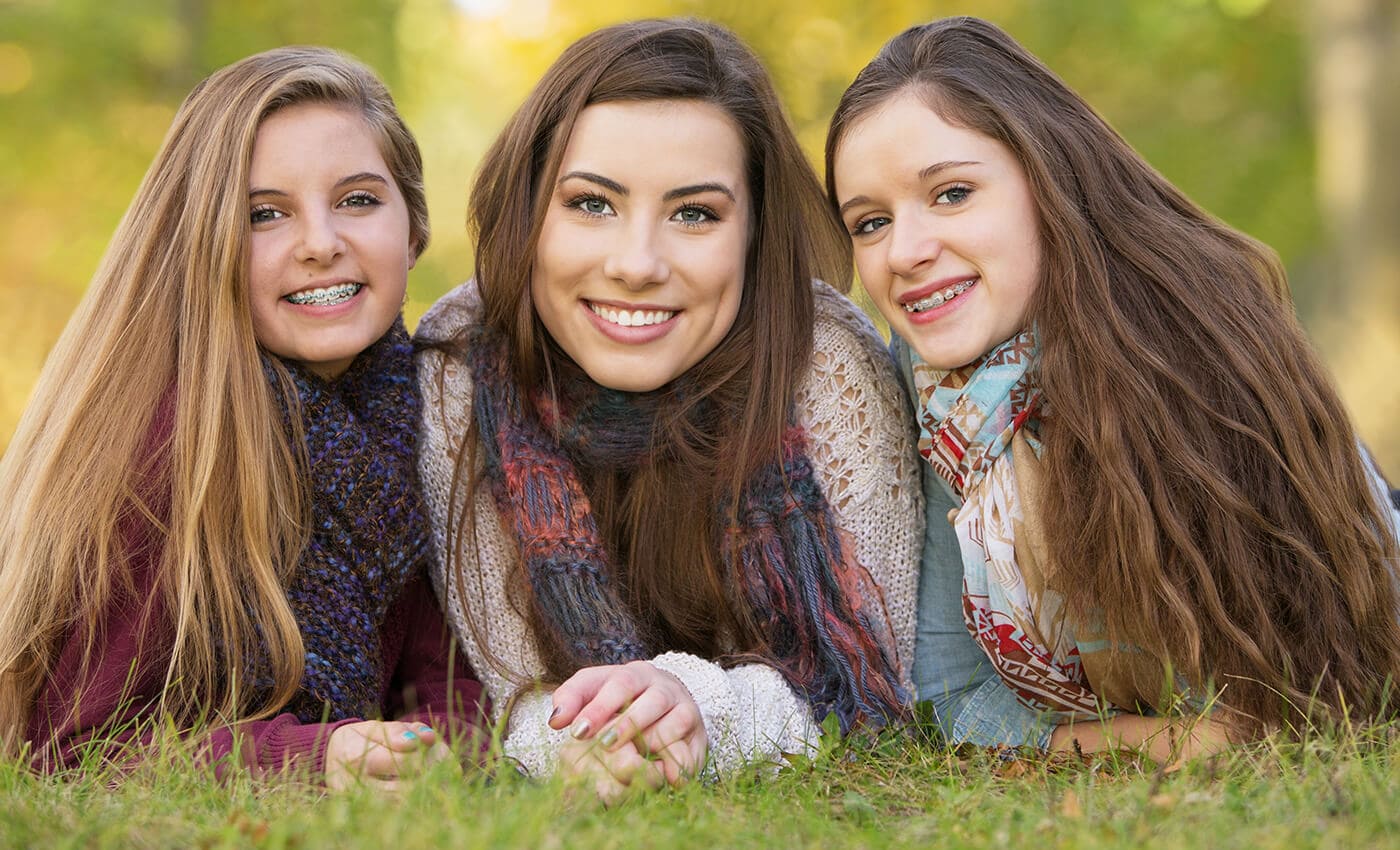 mother with two daughters that have braces